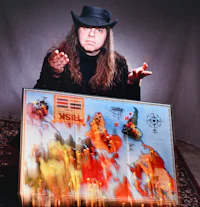 a man in a hat holding up a map