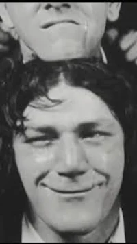 a black and white photo of two men posing for a picture